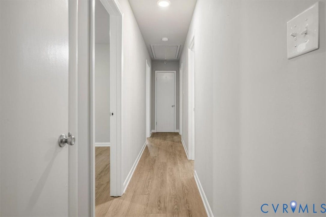 4400 Treely Road, Chesterfield, VA 23831 Hallway featuring wood-finish flooring, light gray wall paint, and white trim