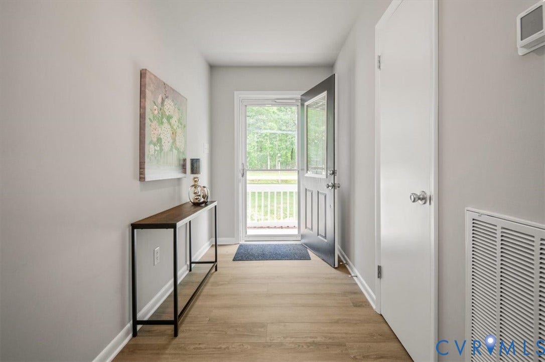 4400 Treely Road, Chesterfield, VA 23831 Entryway featuring light wood-finish flooring, light gray walls, white trim, and a dark paneled door with glass inserts