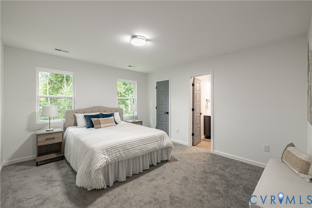 1516 Custer Street, Richmond, VA 23222 Spacious interior room featuring light gray walls, plush gray carpeting, two windows, and multiple panel doors