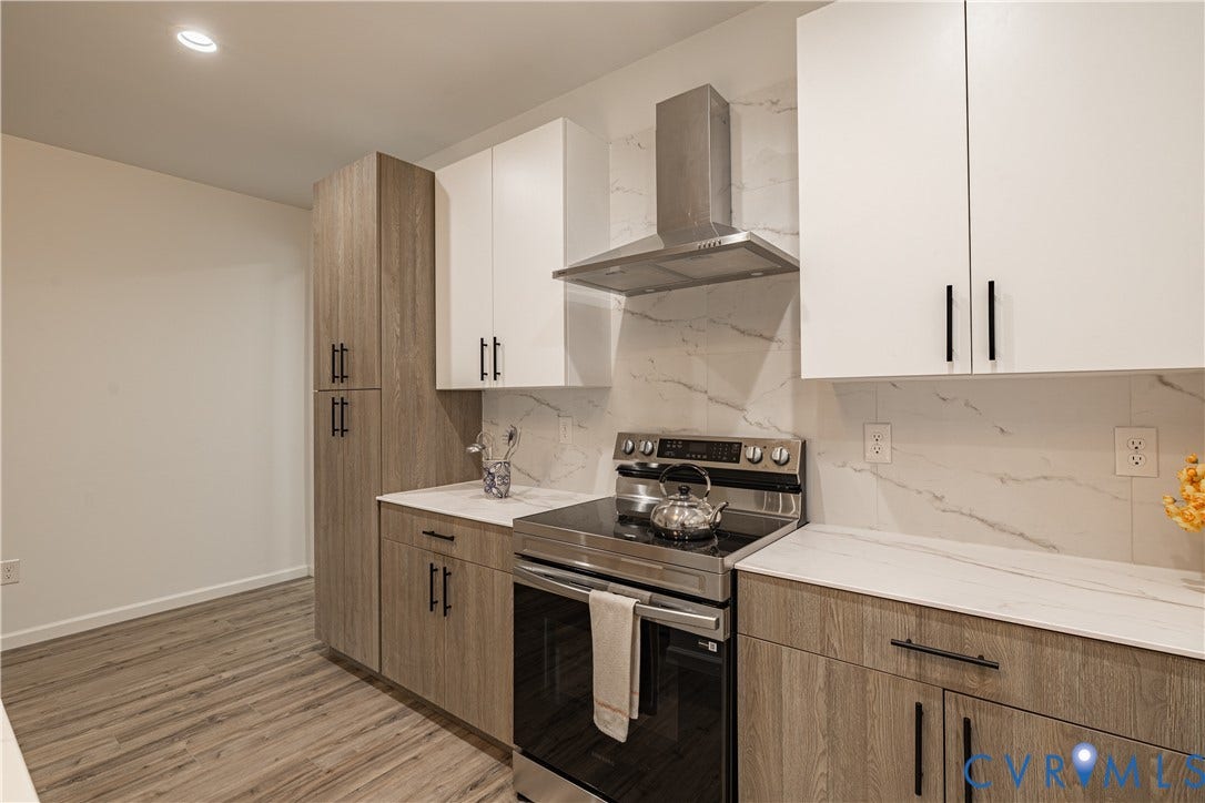 1516 Custer Street, Richmond, VA 23222 Modern kitchen featuring two-tone cabinetry, stainless steel range with a ventilation hood, and white countertops with a coordinating backsplash