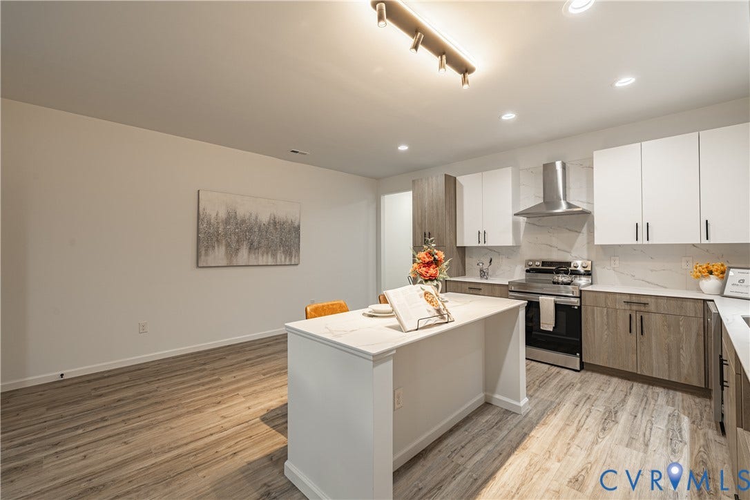 1516 Custer Street, Richmond, VA 23222 Contemporary kitchen featuring a central island, stainless steel appliances, two-tone cabinetry, stone countertops, and wood-finish flooring