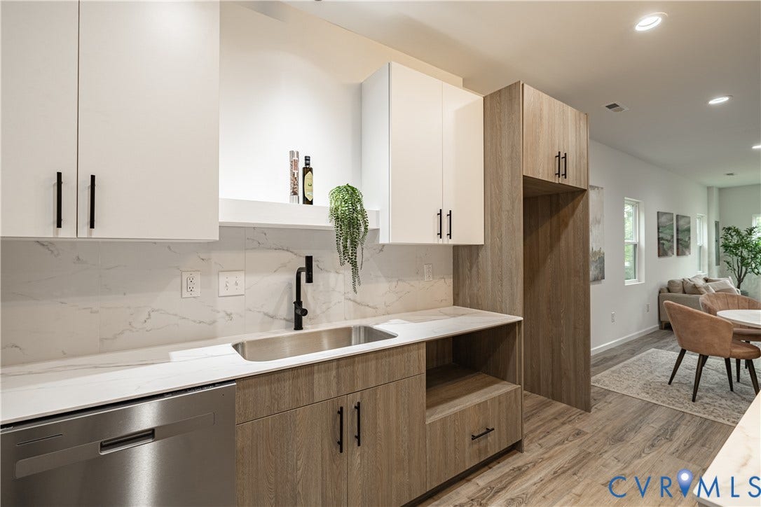 1516 Custer Street, Richmond, VA 23222 Modern kitchen featuring white and wood-finish cabinetry, a stainless steel sink with a matte black faucet, a stainless steel dishwasher, and stone-look countertops with a matching backsplash
