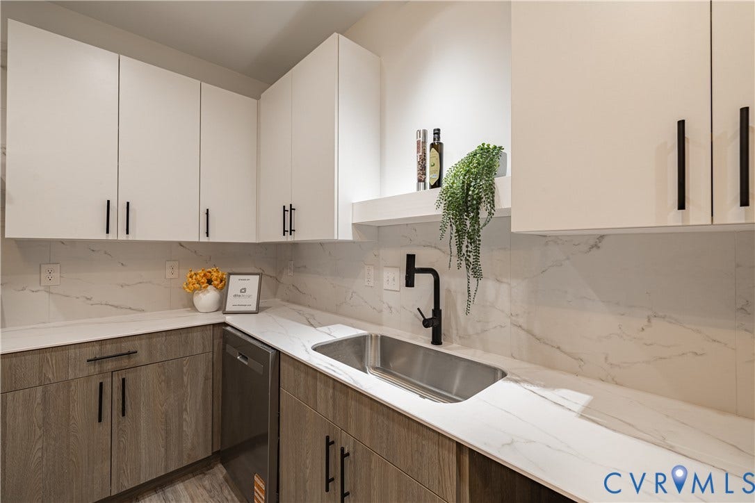 1516 Custer Street, Richmond, VA 23222 Modern kitchen featuring white upper cabinetry, wood-finish lower cabinetry, and sleek black hardware