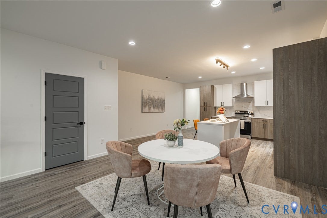 1516 Custer Street, Richmond, VA 23222 Open-concept living space featuring wood-finish flooring, a contemporary kitchen with white and wood-finish cabinetry, a central island, and a stainless steel appliance suite