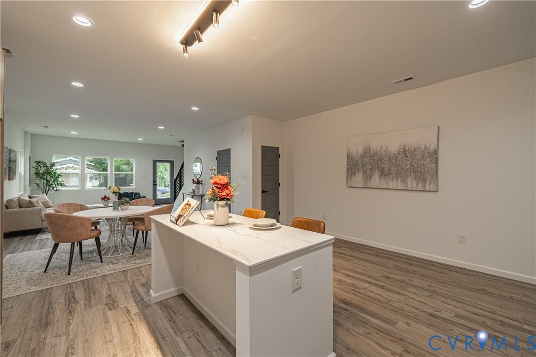 1516 Custer Street, Richmond, VA 23222 Spacious open-concept living area featuring wood-finish flooring, a kitchen island with a light-toned countertop, and recessed ceiling lighting