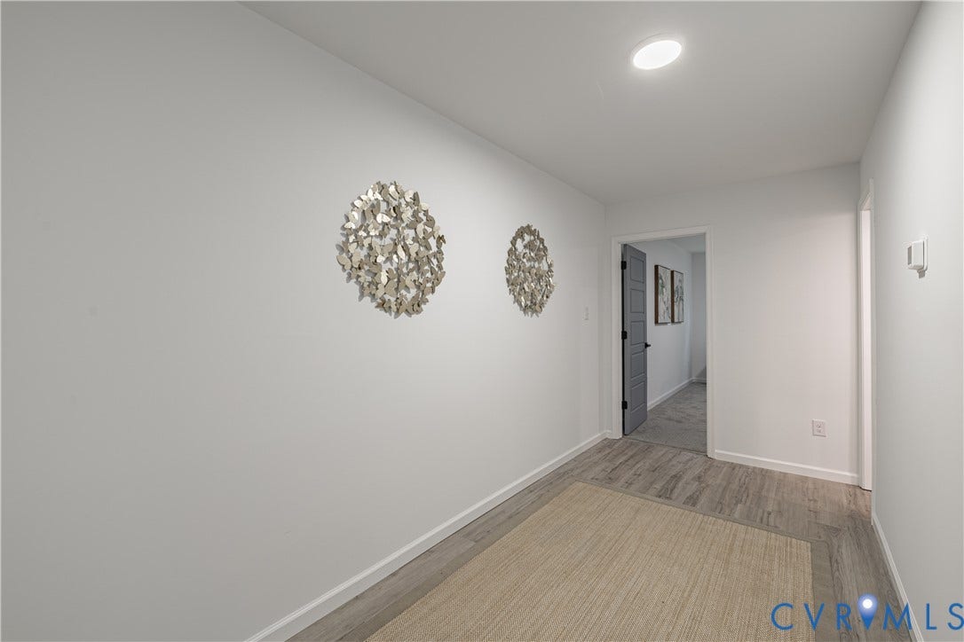 1516 Custer Street, Richmond, VA 23222 Recessed lighting illuminates the hallway, featuring wood-finish flooring and neutral wall tones