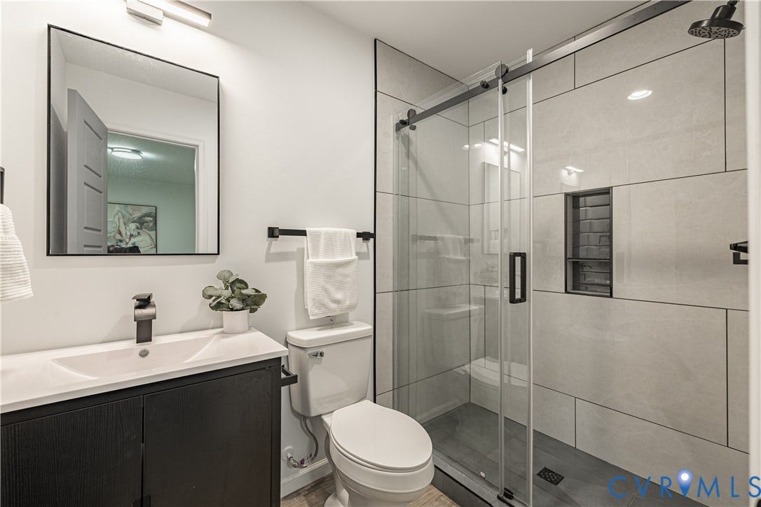 1516 Custer Street, Richmond, VA 23222 Bathroom featuring a modern vanity with integrated sink, sleek black faucet, and rectangular framed mirror