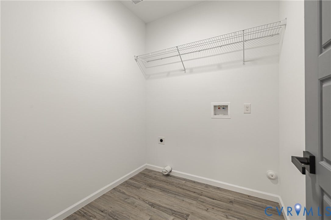 1516 Custer Street, Richmond, VA 23222 Utility area featuring wood-finish flooring, white walls, and a wire shelf for storage