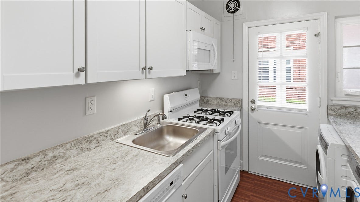3517 Hanover Avenue, #B, Museum District, Richmond, VA 23221 Compact kitchen featuring white cabinetry, a built-in microwave, a gas range, and a stainless steel sink