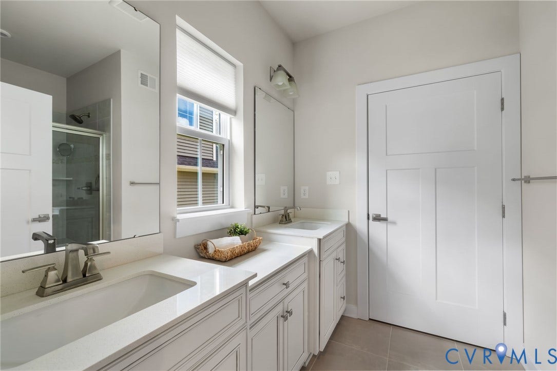 6249 Deer Summit Court, Charleston Club, Moseley, VA 23120 Dual vanity with integrated sinks and brushed nickel faucets, set against white cabinetry with matching countertops