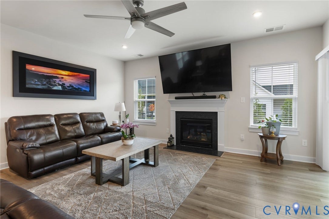 6249 Deer Summit Court, Charleston Club, Moseley, VA 23120 Living area featuring LVP flooring, a ceiling fan, recessed lighting, and a gas fireplace with a white mantel and dark surround