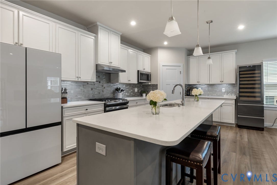 6249 Deer Summit Court, Charleston Club, Moseley, VA 23120 White shaker-style cabinetry, quartz countertops, stainless steel appliances, LVP, central island with seating