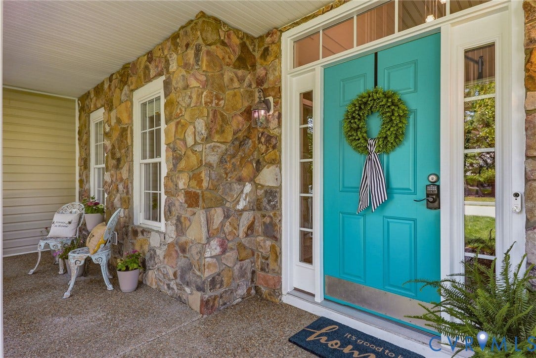 7618 Hampton Green Drive, Chesterfield, VA 23832 Stone facade exterior with a vibrant turquoise front door, flanking sidelight windows, and transom window