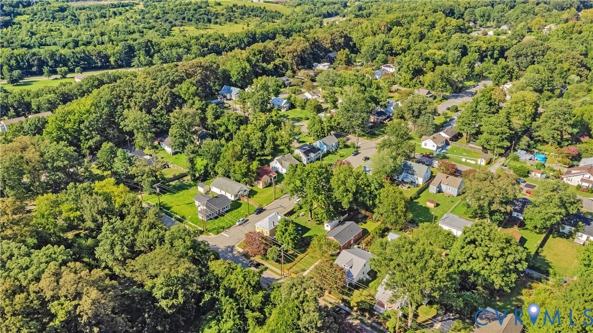 4502 Bunn Avenue, Fulton, Richmond, VA 23231 Lush, tree-lined neighborhood featuring residential homes with diverse architectural styles, ample green spaces, and paved streets