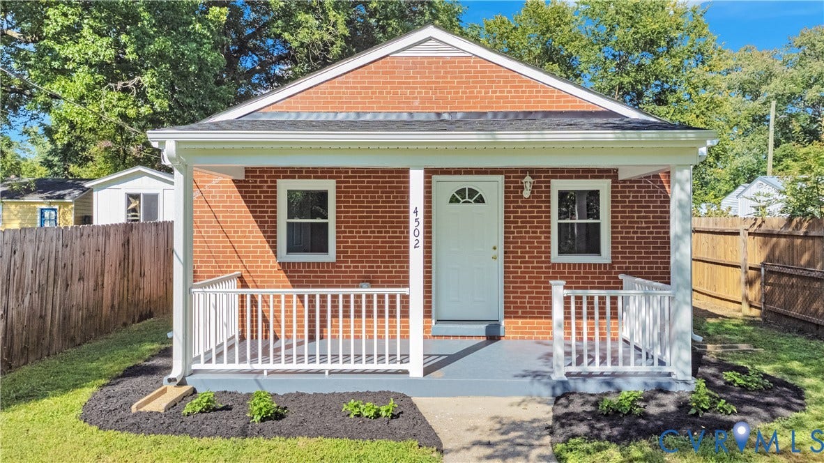 4502 Bunn Avenue, Fulton, Richmond, VA 23231 Brick exterior featuring a covered front porch with white railings, a white entry door, and a black shingle roof