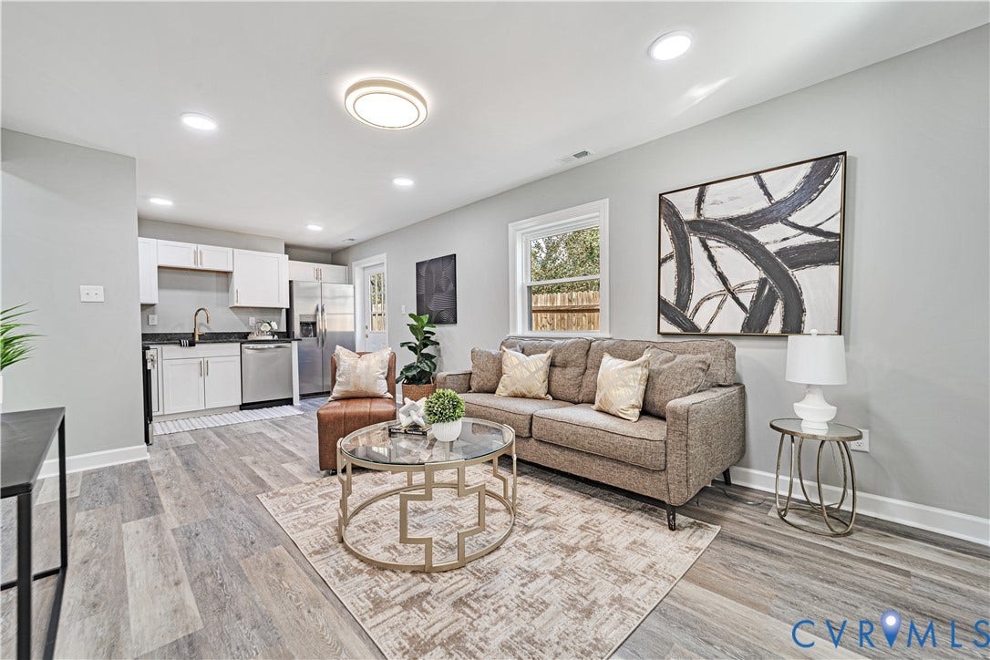 4502 Bunn Avenue, Fulton, Richmond, VA 23231 Open-concept living area featuring wood-finish flooring, recessed lighting, and a kitchen with stainless steel appliances, white cabinetry, and a dark stone countertop
