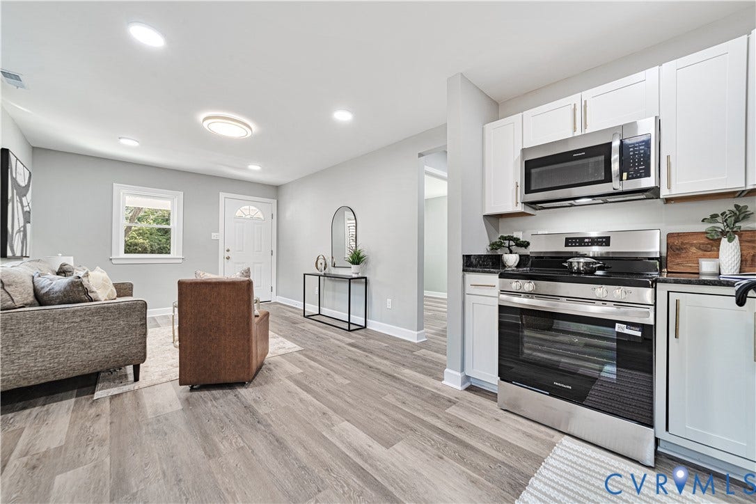 4502 Bunn Avenue, Fulton, Richmond, VA 23231 Open-concept living space with wood-finish flooring, recessed lighting, and a white paneled front door