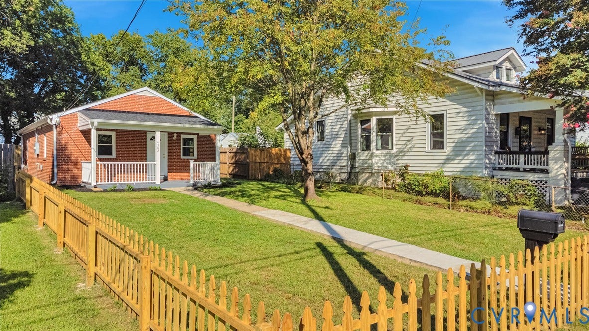 4502 Bunn Avenue, Fulton, Richmond, VA 23231 Red brick facade home with a front porch featuring white railings