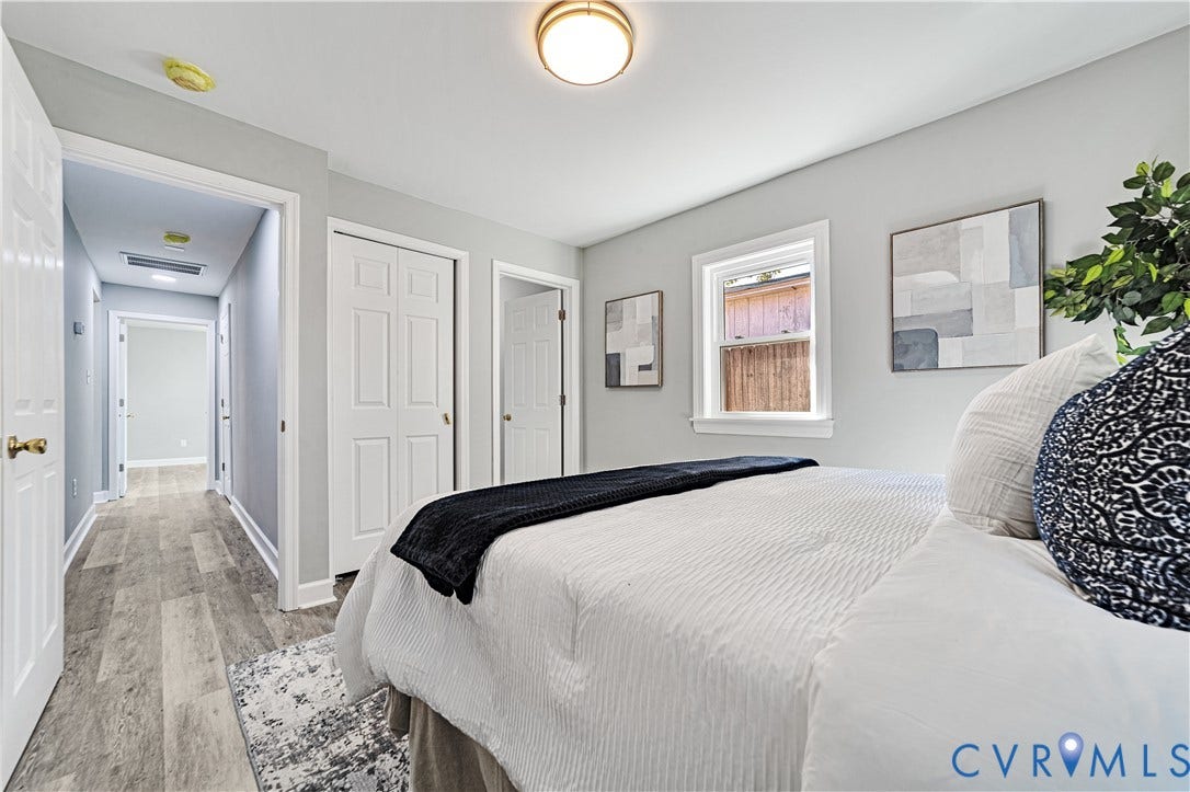 4502 Bunn Avenue, Fulton, Richmond, VA 23231 Bedroom featuring light gray walls, wood-finish flooring, a single window, and white bi-fold closet doors