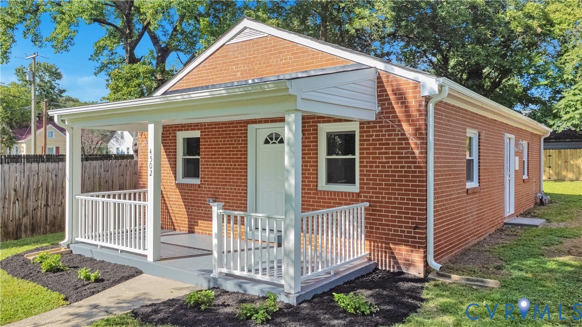 4502 Bunn Avenue, Fulton, Richmond, VA 23231 Brick exterior with white trim, featuring a covered front porch with white railings