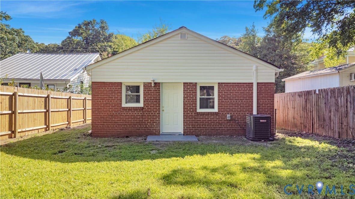 4502 Bunn Avenue, Fulton, Richmond, VA 23231 Rear exterior featuring brick and siding finishes, two windows, and a central entry door