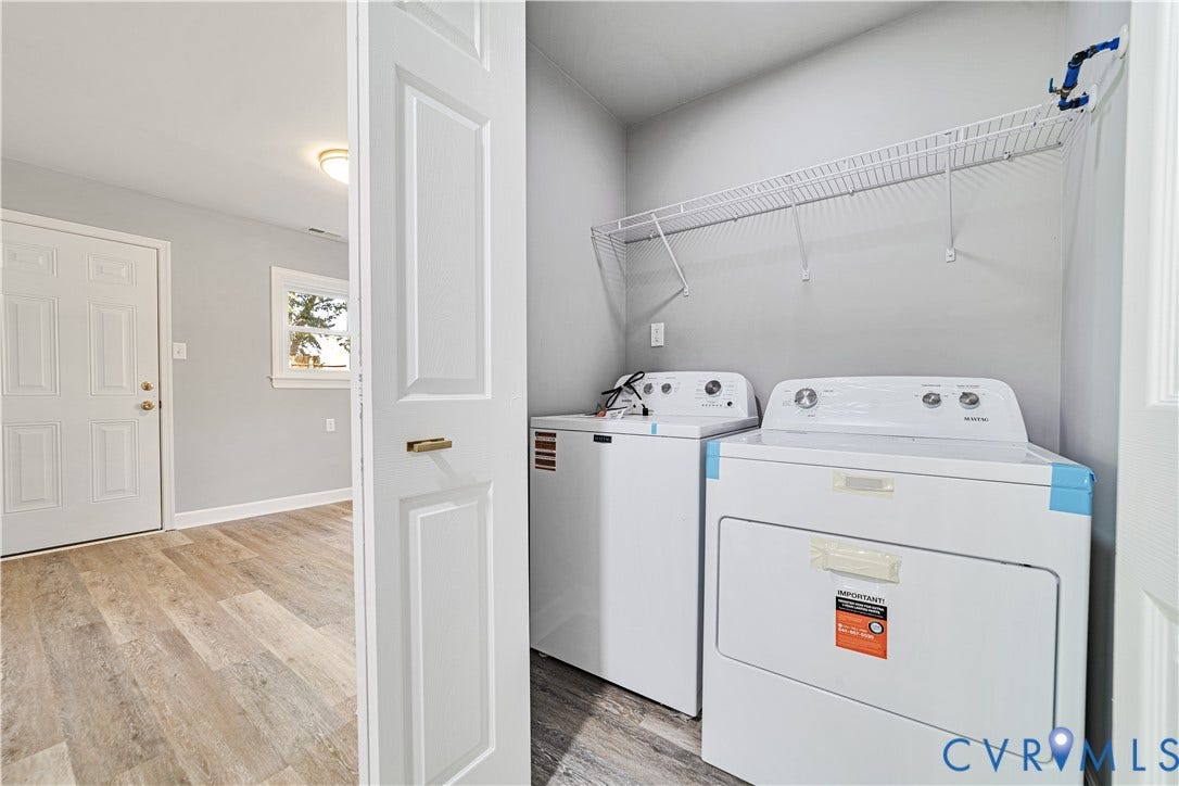 4502 Bunn Avenue, Fulton, Richmond, VA 23231 Dedicated laundry area featuring a white wire shelf, durable wood-finish flooring, and a paneled white door