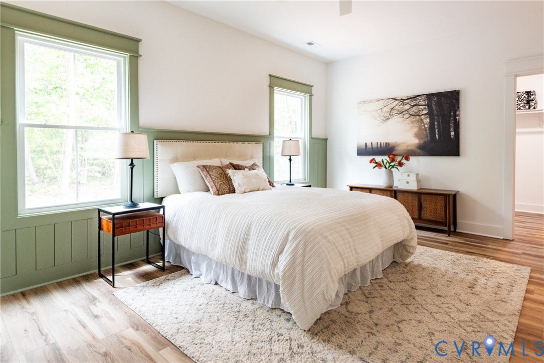 Spacious room featuring LVP flooring and a light-toned area rug