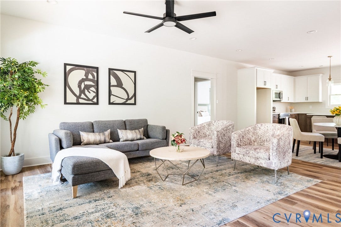 Open-concept living space featuring LVP flooring, recessed lighting, and a modern ceiling fan