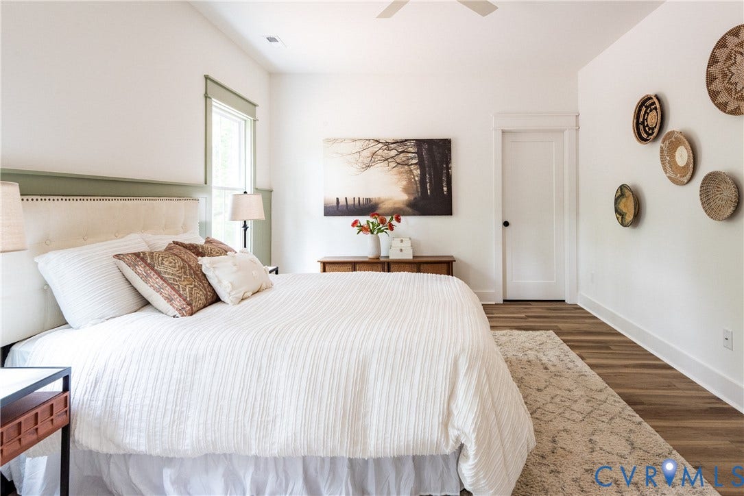 Spacious room featuring LVP flooring, white walls, and a recessed window with green trim