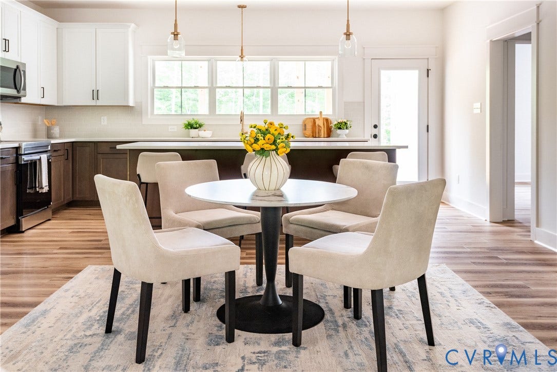 Open-concept kitchen and dining area featuring LVP flooring