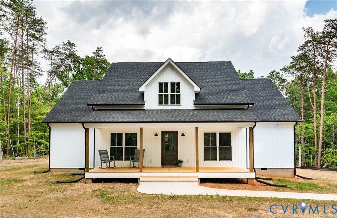 Modern farmhouse residence featuring white board and batten siding