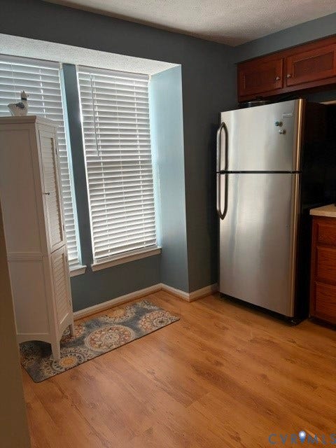 4900 Finnegan Court, Henrico, VA 23228 Wood-finish flooring with white trim, double windows, stainless steel refrigerator, and wood cabinetry