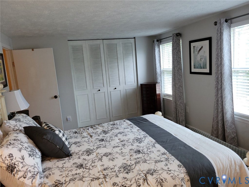 4900 Finnegan Court, Henrico, VA 23228 White louvered bi-fold doors, two windows with blinds, and white painted walls