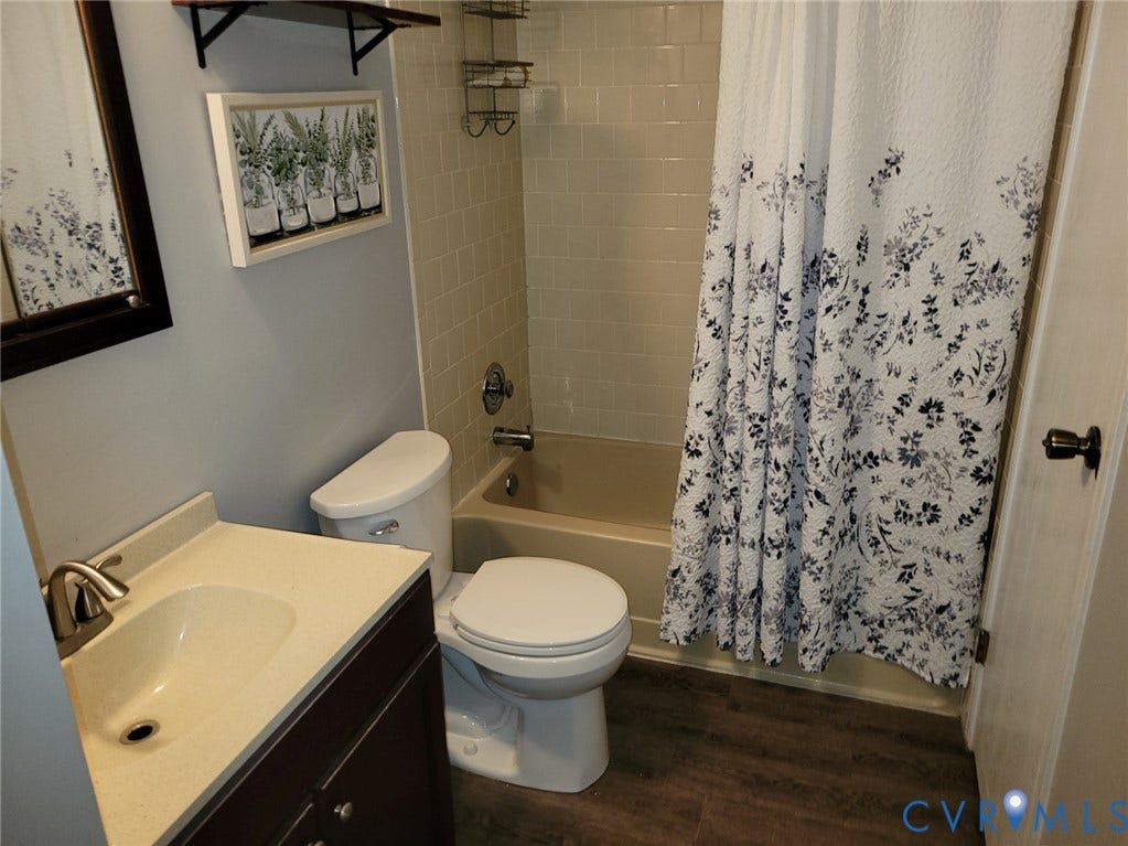 4900 Finnegan Court, Henrico, VA 23228 Bathroom featuring a built-in tub with shower, vanity with an integrated sink, and wood-finish flooring