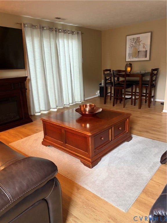 4900 Finnegan Court, Henrico, VA 23228 Wood-finish flooring throughout, with a built-in fireplace featuring a dark wood mantel
