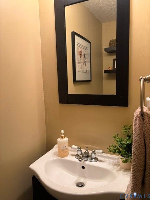 4900 Finnegan Court, Henrico, VA 23228 Pedestal sink with chrome faucet, framed mirror, and floating wall shelves