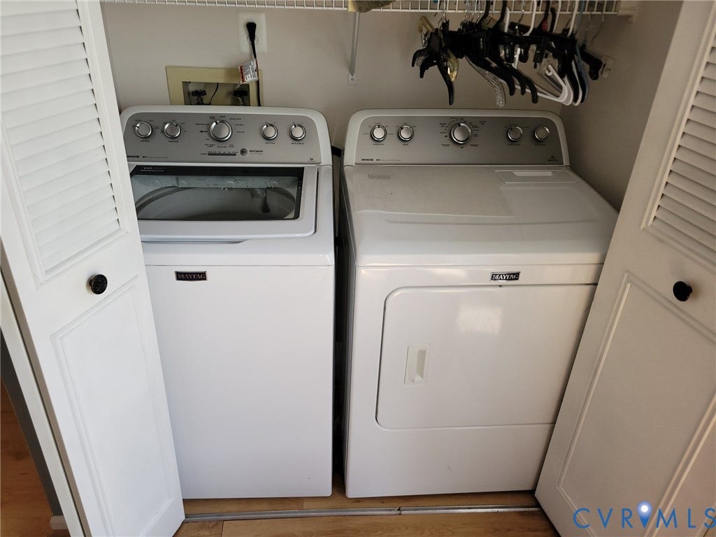 4900 Finnegan Court, Henrico, VA 23228 Dedicated laundry closet featuring a white Maytag washer and dryer set, bi-fold louvered doors, and overhead wire shelving