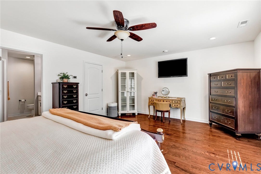 14379 Michaux Village Drive, Winterfield Park, Midlothian, VA 23113 Spacious room featuring wood-finish flooring, a ceiling fan with integrated lighting, and white walls