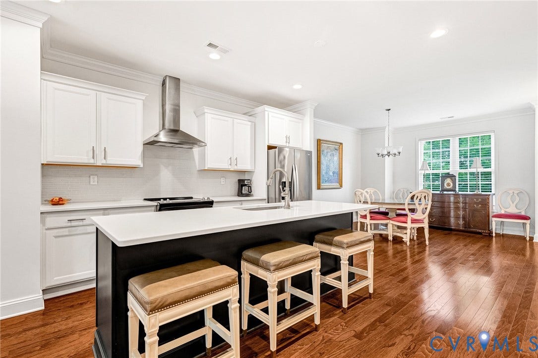 14379 Michaux Village Drive, Winterfield Park, Midlothian, VA 23113 Bright kitchen featuring a central island, white cabinetry, stainless steel appliances, and wood-finish flooring