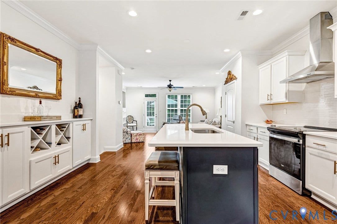 14379 Michaux Village Drive, Winterfield Park, Midlothian, VA 23113 Modern kitchen featuring a central island with seating, stainless steel appliances, white cabinetry, and rich wood-finish flooring