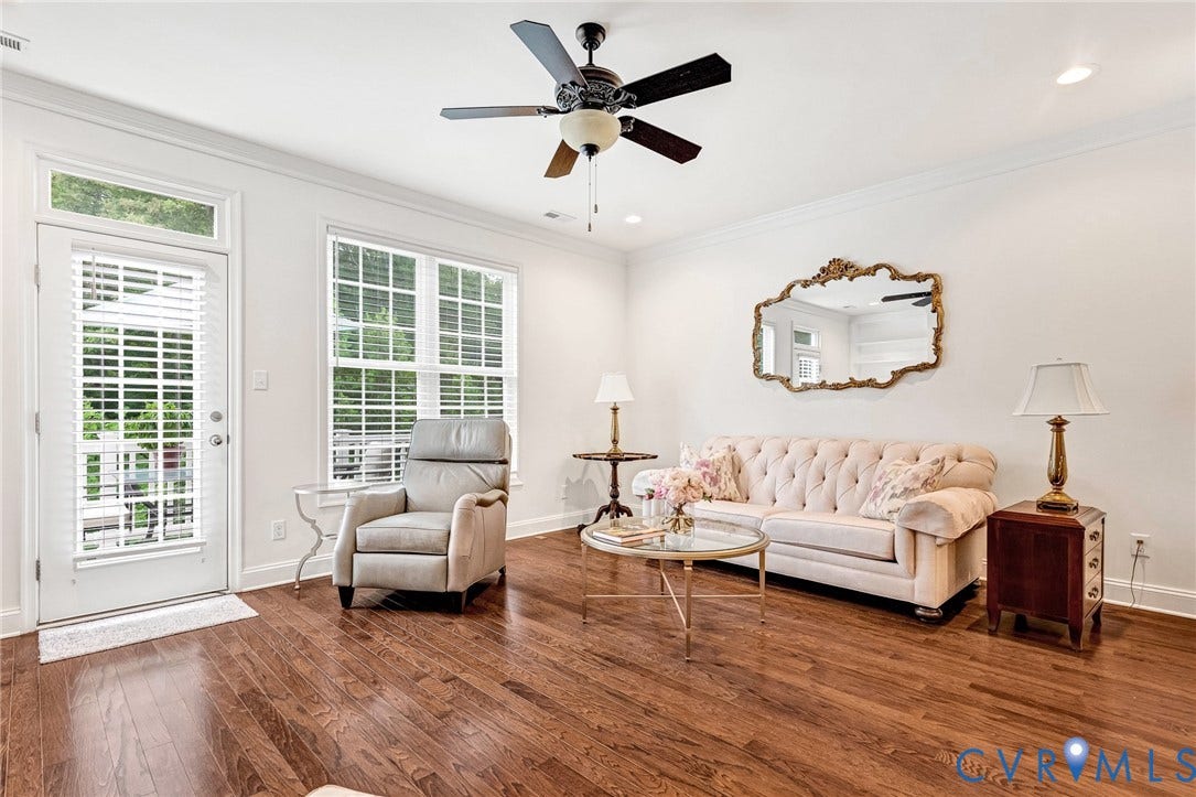 14379 Michaux Village Drive, Winterfield Park, Midlothian, VA 23113 Spacious living area featuring rich wood-finish flooring, white walls, and a multi-pane window with white blinds