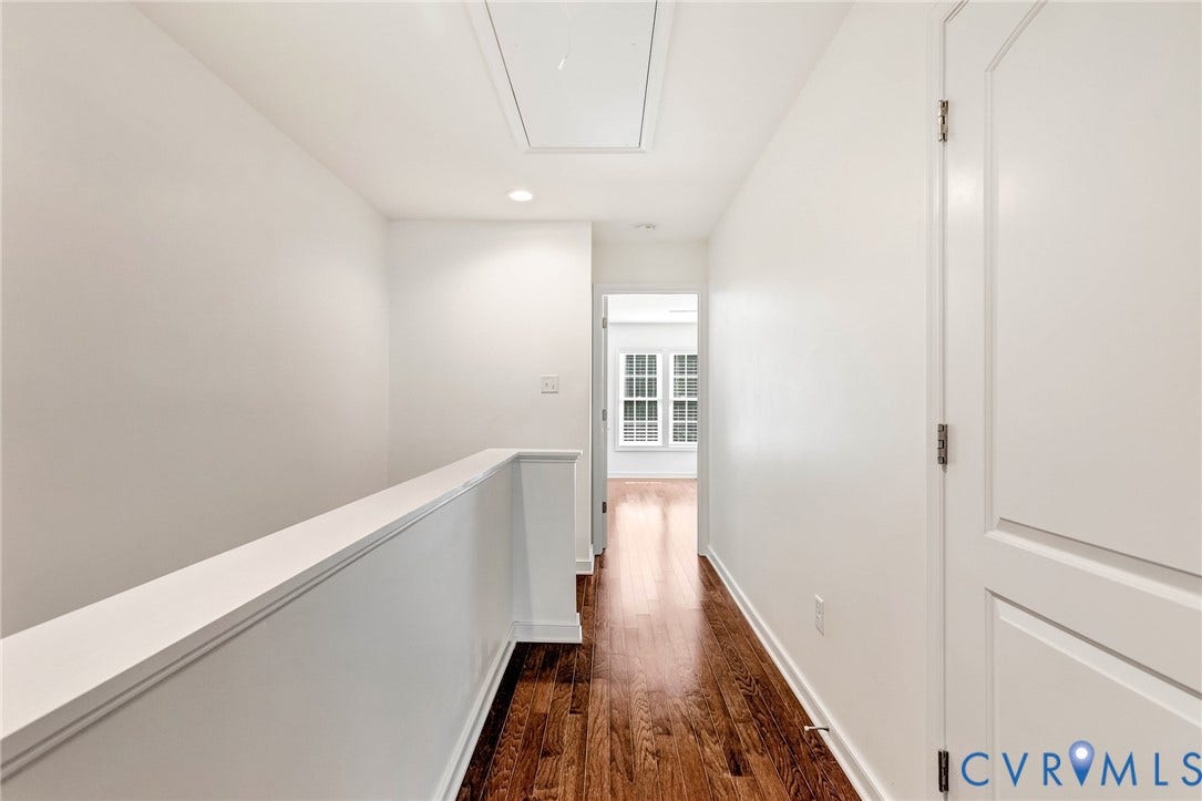 14379 Michaux Village Drive, Winterfield Park, Midlothian, VA 23113 Upper-level hallway featuring hardwood flooring, white walls, and a white doors to the laundry closet.