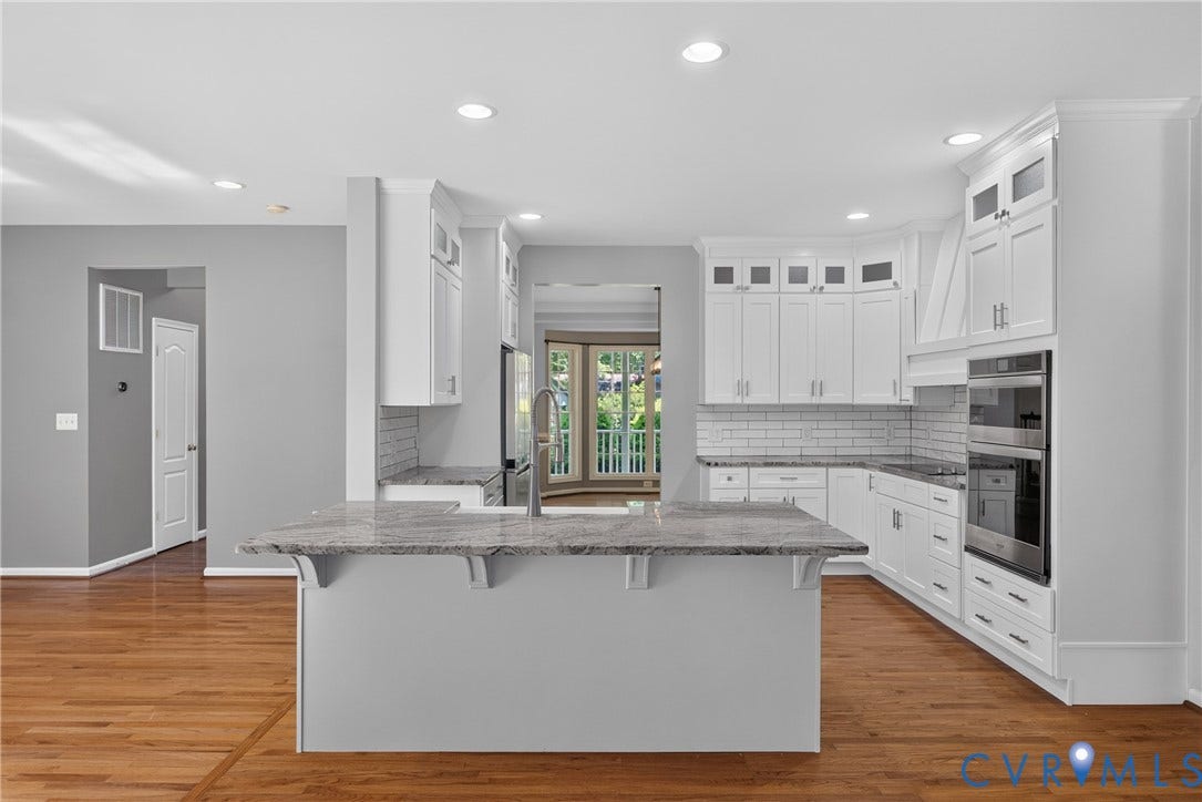 381 Shorewood Drive, Shorewood, Mineral, VA 23117 Kitchen featuring white shaker cabinetry, stainless steel appliances, a subway tile backsplash, and a central island with a stone countertop