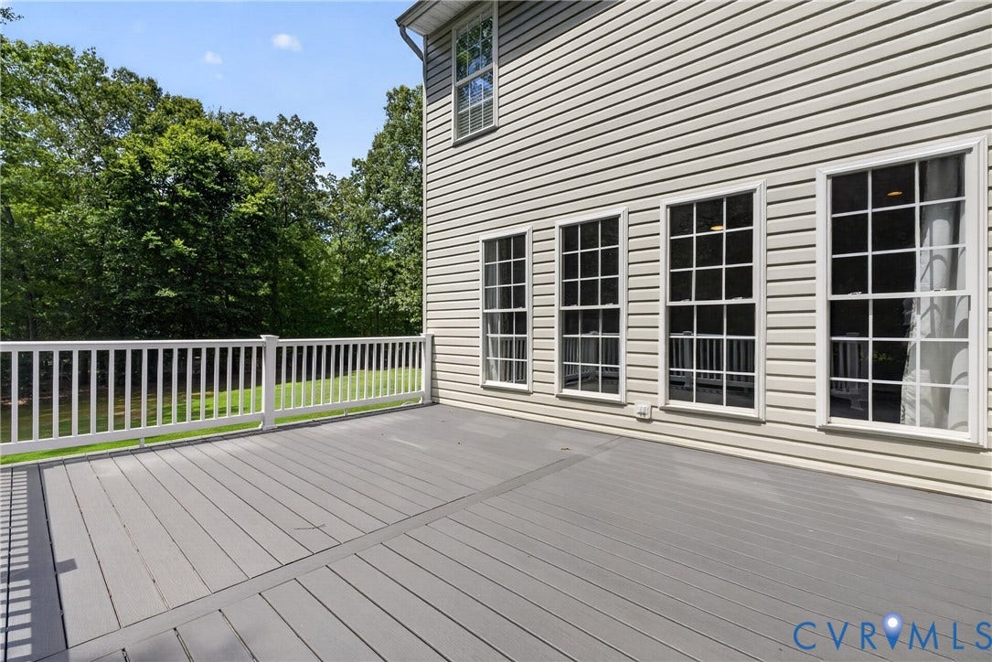 381 Shorewood Drive, Shorewood, Mineral, VA 23117 Spacious outdoor deck with grey composite decking, white railing, and ample natural light from multiple grid-paned windows