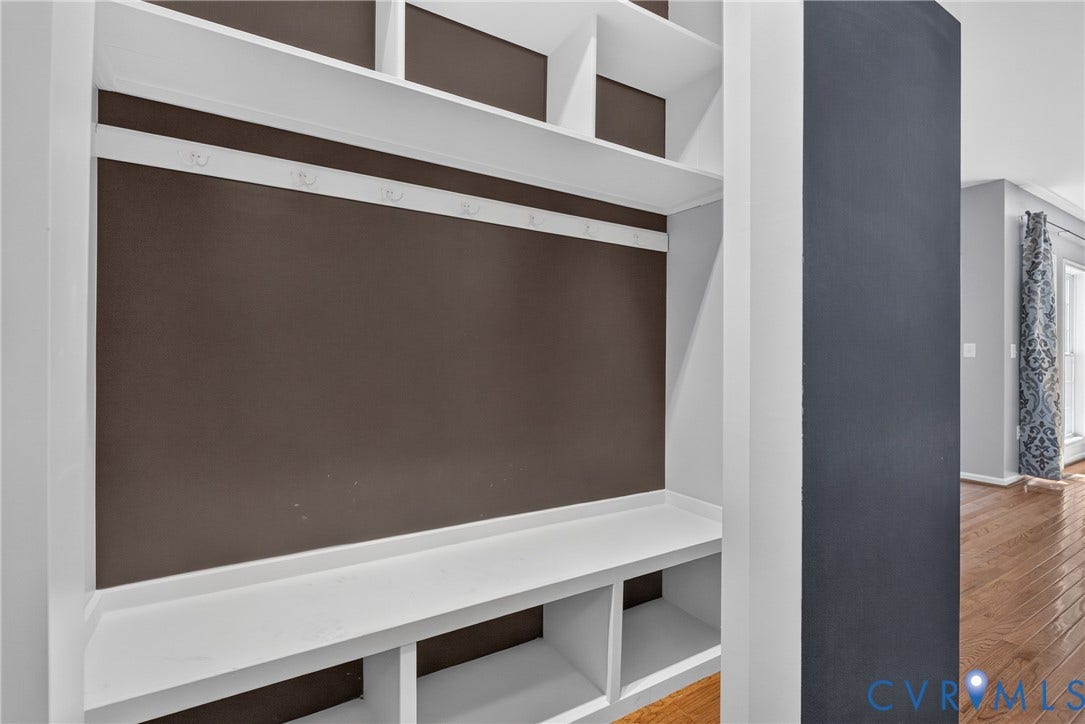 381 Shorewood Drive, Shorewood, Mineral, VA 23117 Built-in storage solution featuring white shelving, integrated bench seating, and wall-mounted hooks