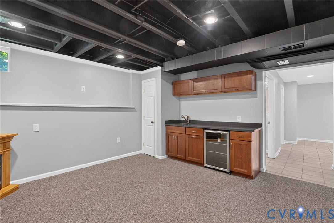 381 Shorewood Drive, Shorewood, Mineral, VA 23117 Recreation room with gray carpeting, an exposed black ceiling, recessed lighting, and a built-in wet bar featuring wood cabinetry, a sink, and a beverage refrigerator