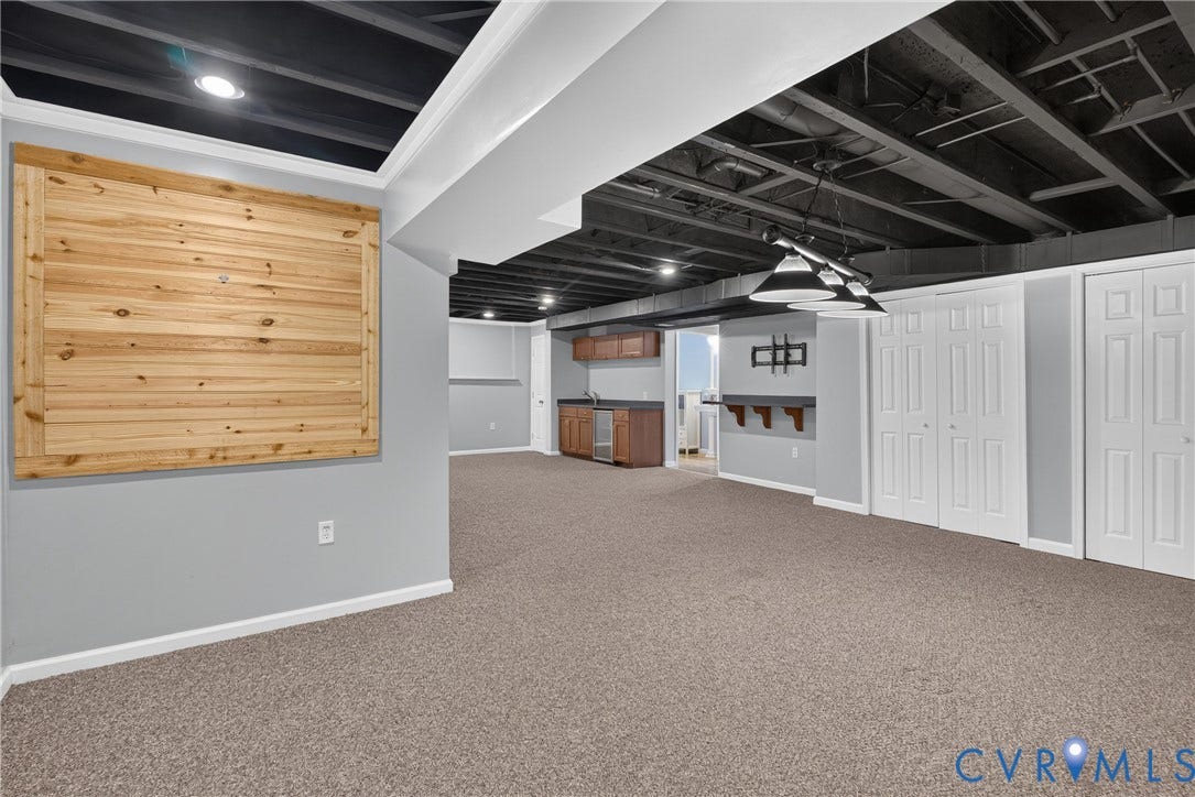 381 Shorewood Drive, Shorewood, Mineral, VA 23117 Finished basement featuring carpeted flooring and exposed black-painted ceiling joists
