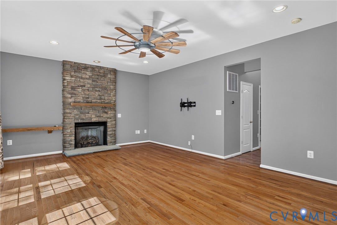 381 Shorewood Drive, Shorewood, Mineral, VA 23117 Living area featuring a stone-clad fireplace with a wood mantel, wood-finish flooring, and recessed lighting