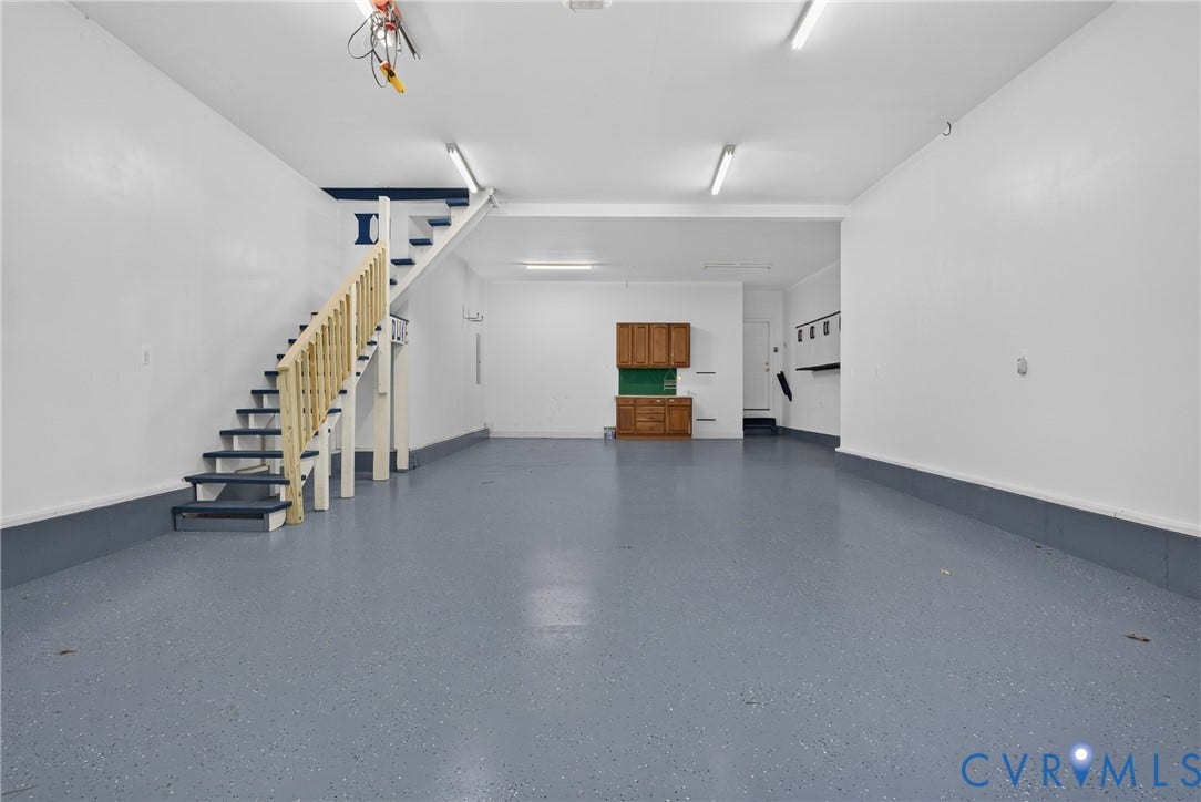 381 Shorewood Drive, Shorewood, Mineral, VA 23117 Spacious garage with an epoxy-coated concrete floor and white walls