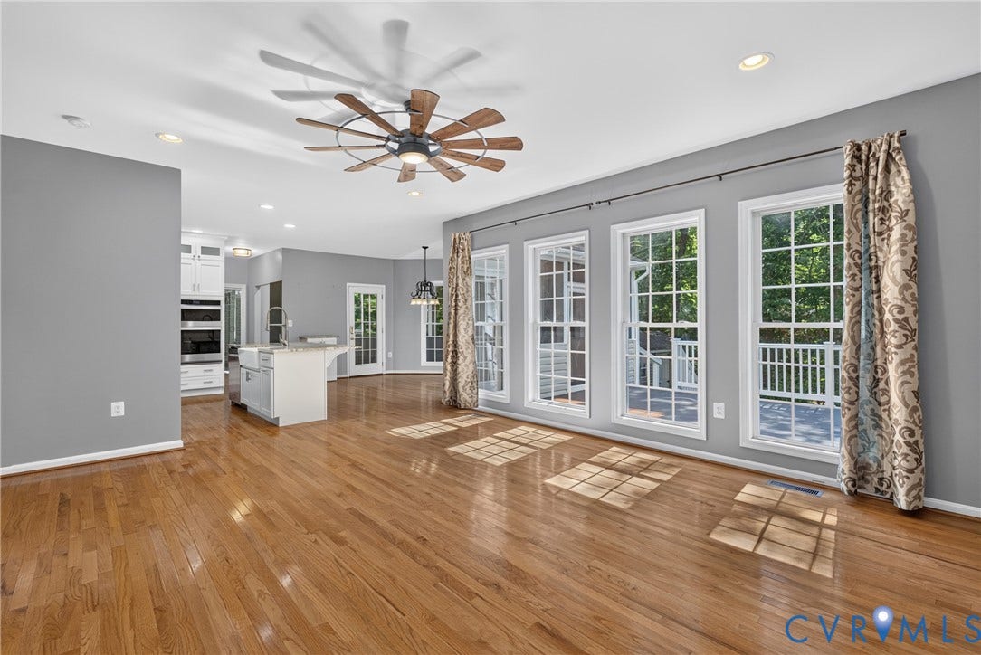 381 Shorewood Drive, Shorewood, Mineral, VA 23117 Expansive living area with wood-finish flooring, recessed lighting, and a multi-blade ceiling fan